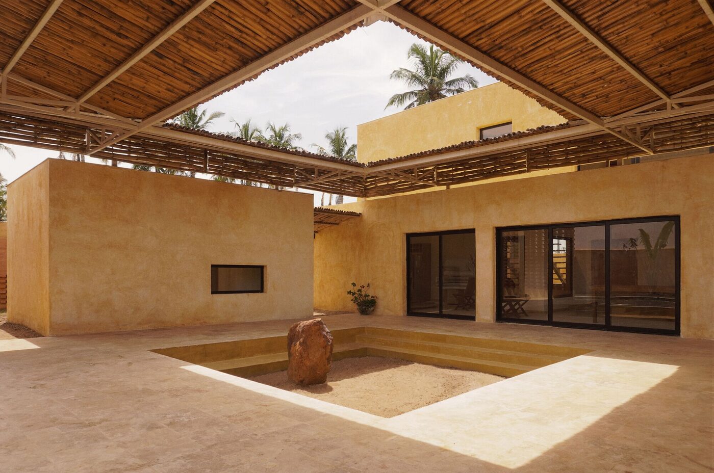 Compound-house concept rendering with private rooms around a shared courtyard